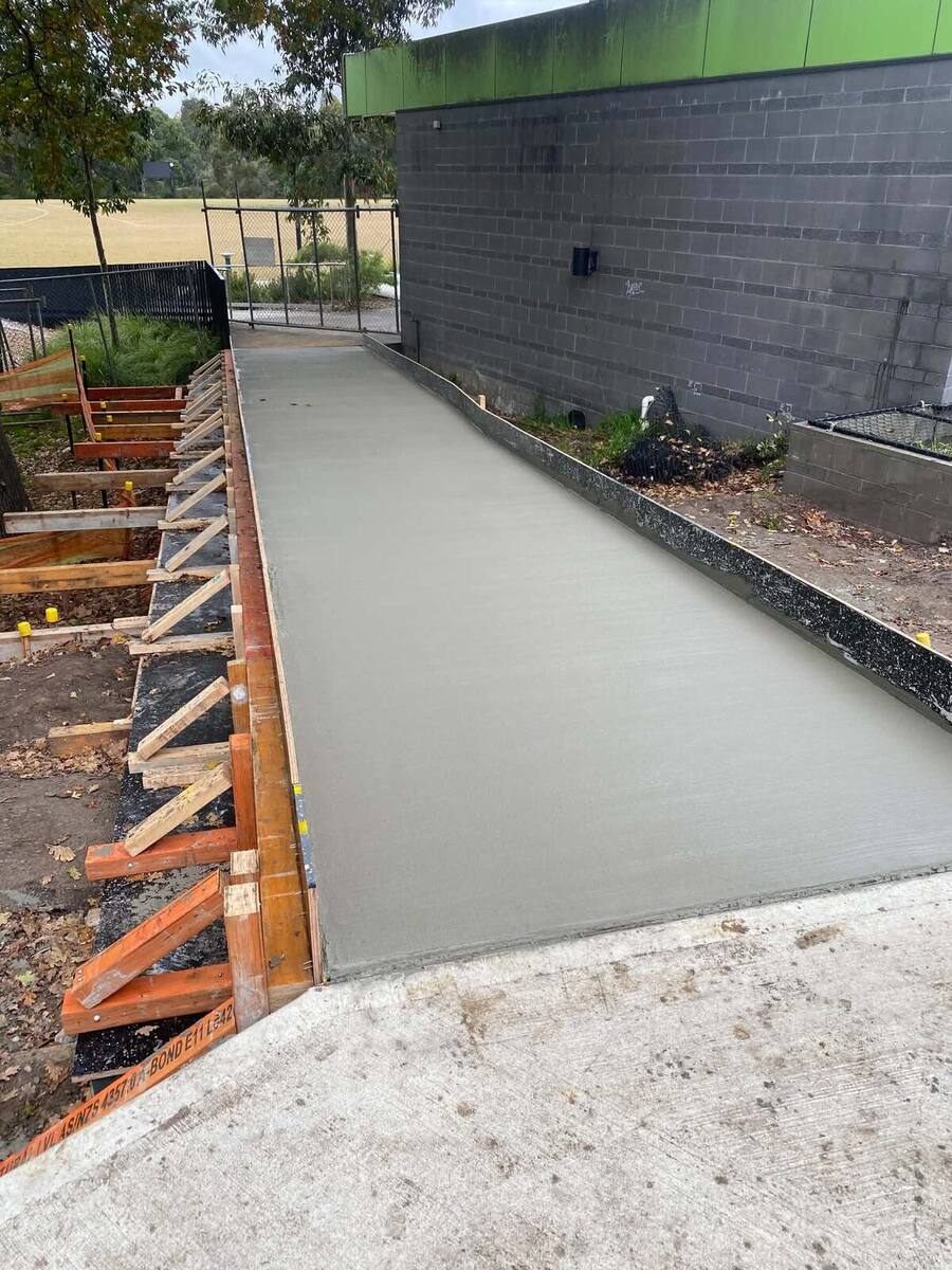 Freshly poured footpath with timber formwork and edging detail
