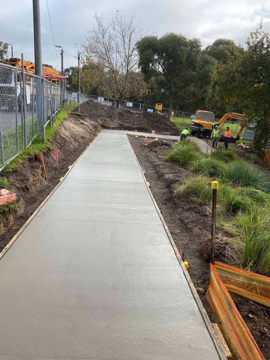Crew and excavator on a footpath and landscaping job in Victoria